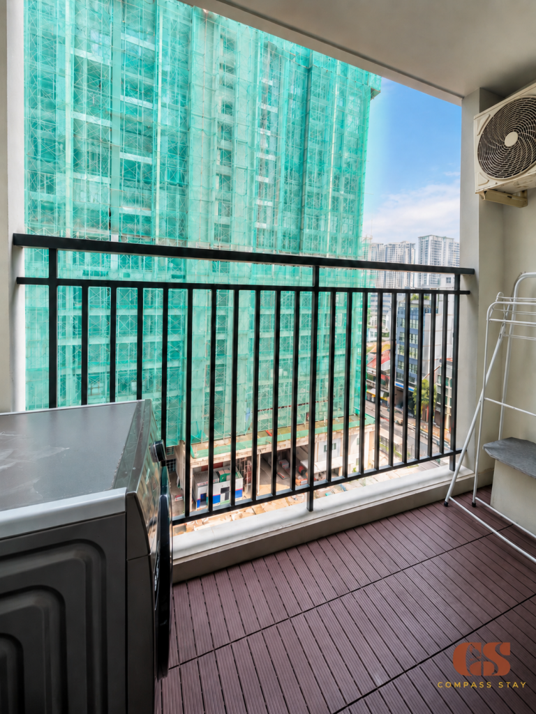 Long-stay serviced apartment in District 1 HCMC with a private washing machine on the balcony.